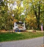 Camper in wooded area.